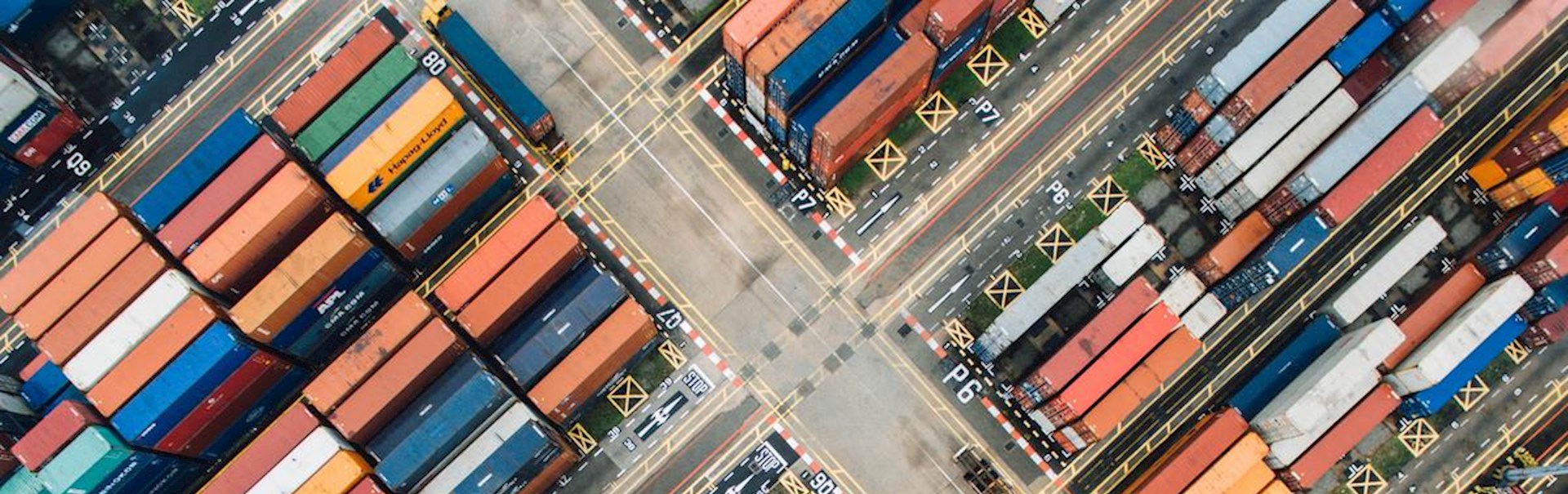 Aerial view of shipping containers stacked in the in the terminal yard.